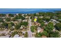 Aerial view of the home nestled in a lush, green neighborhood with access to water at 1424 Castleworks Ln, Tarpon Springs, FL 34689