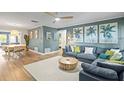 Bright living room with ample seating, stylish decor, and wood flooring throughout at 1596 Idle Dr, Clearwater, FL 33756