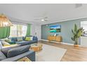 Comfortable living room area with stylish furniture, modern lighting, and neutral tones at 1596 Idle Dr, Clearwater, FL 33756