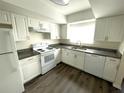 Bright kitchen with white cabinets, modern appliances, and granite countertops at 1610 58Th S Ave # 6, St Petersburg, FL 33712