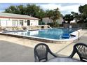 Community pool area with clear blue water, poolside seating, and palm trees at 1610 58Th S Ave # 6, St Petersburg, FL 33712
