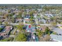Expansive aerial view of the home and neighborhood showcasing the pool and proximity to community amenities at 2217 Stacy Ct, Dunedin, FL 34698