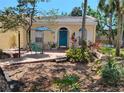 Inviting yellow home with a bright blue door and well-maintained landscaping at 2512 W Texas Ave # C, Tampa, FL 33629