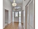 Elegant foyer showcasing beautiful floors, chandelier, and a front door with sidelights at 322 Northway Dr, Sun City Center, FL 33573