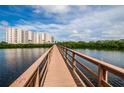Condo building with water views from a wooden boardwalk under a blue sky at 4516 Seagull Dr # 615, New Port Richey, FL 34652