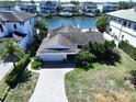 Beautiful single-Gathering home with attached garage and a driveway surrounded by lush, mature landscaping at 5110 W Poe Ave, Tampa, FL 33629