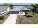 Charming single-story home with a well-manicured lawn, an American flag, and a spacious two-car garage at 613 Fort Duquesna Dr, Sun City Center, FL 33573