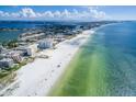 Scenic aerial view of a white sandy beach and clear blue water, perfect for vacation getaways at 6161 Gulf Winds Dr # 338, St Pete Beach, FL 33706