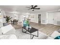 An expansive open-concept living area with a modern sofa, leading to a dining area and kitchen at 6227 12Th Ave, New Port Richey, FL 34653