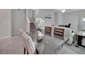 Inviting dining area with views of the staircase, living room, and front entry at 6325 Shore Vista Pl, Apollo Beach, FL 33572