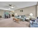Comfortable living room with ceiling fan, with view into the dining room at 6375 Ocean Pines Ln, Spring Hill, FL 34606