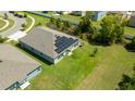 Aerial view of a home with solar panels, a well-maintained lawn, and situated in a quiet neighborhood at 6416 Cobble Bliss St, Zephyrhills, FL 33541