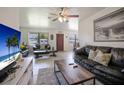 Bright living room featuring tile floors, ceiling fan, and large windows at 6936 77Th N Ter, Pinellas Park, FL 33781
