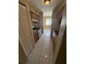 Efficient kitchen featuring tile floors, wooden cabinets and modern stainless steel appliances at 7507 Presley Pl # D, Tampa, FL 33617