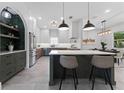 Gourmet kitchen with a marble island, stainless steel appliances, and designer lighting at 806 W Adalee St, Tampa, FL 33603