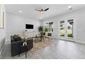 Bright and airy living room with tile floors, modern furniture, and access to the backyard at 806 W Adalee St, Tampa, FL 33603