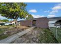 Front yard of home featuring gated front entrance, walkway, and secure fence at 8325 Elkwood Ln, Tampa, FL 33615