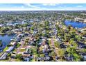 Expansive aerial view of a neighborhood with waterfront homes, lush greenery, and lake access at 9107 Bay Ne St, St Petersburg, FL 33702