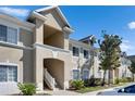 Exterior of a two-story condo in a community featuring multiple windows and neutral color palette at 9516 Amberdale Ct # 202, Riverview, FL 33569