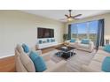 Bright living room featuring plush seating, a sleek entertainment center, and a large window with scenic views at 10851 Mangrove Cay Ne Ln # 714, St Petersburg, FL 33716