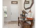 Elegant foyer features stylish table décor, a decorative mirror, and natural light at 10924 Brightleaf Ct, Riverview, FL 33569