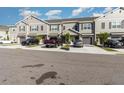 Exterior view of townhomes with gray exteriors, dark shutters, driveways, and landscaping at 10924 Brightleaf Ct, Riverview, FL 33569