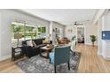 Bright living room featuring large windows, wood flooring, and comfortable seating, creating a welcoming atmosphere at 1165 63Rd S Ave, St Petersburg, FL 33705
