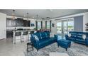 Open-concept living space with modern furnishings, stylish decor, and seamless access to the outdoors at 12315 Dora Trail, Parrish, FL 34219