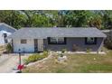 Beautiful home showcasing a well maintained front lawn and a welcoming entrance at 1655 Owen Dr, Clearwater, FL 33759