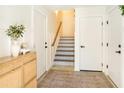 Bright foyer featuring a staircase with decorative tiles, modern accents, and white trim at 1725 Massachusetts Ne Ave, St Petersburg, FL 33703