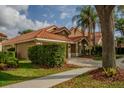Beautiful exterior view of a single-Gathering home with lush greenery and a well-manicured lawn at 18919 Place Marquette, Lutz, FL 33558