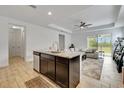 Modern kitchen featuring a dark wood island, granite countertops, stainless steel appliances, and open access to the living room at 19624 Lonesome Pine Dr, Land O Lakes, FL 34638