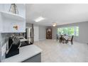 Open kitchen and dining area with stainless steel appliances, tile backsplash, and large bay window with natural light at 2229 Americus W Blvd # 25, Clearwater, FL 33763