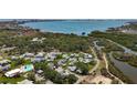 Aerial view of community featuring waterfront access, pool, and lush greenery at 3203 40Th S Way # B, St Petersburg, FL 33711