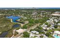 Aerial view of the community featuring lush greenery, a pond, and nearby amenities at 3203 40Th S Way # B, St Petersburg, FL 33711
