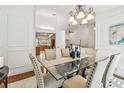 Formal dining room showcasing vaulted ceilings and a glass table set for six at 3398 Pinnacle S Ct, Palm Harbor, FL 34684