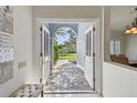 Light and bright entryway with arched doorway and clear view to the outdoors at 3398 Pinnacle S Ct, Palm Harbor, FL 34684