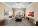 Bright living room with a large arched window, hardwood floors, and cozy neutral-toned furniture at 4207 S Dale Mabry Hwy # 3302, Tampa, FL 33611