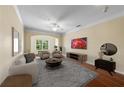 Bright living room with a large arched window, hardwood floors, and cozy neutral-toned furniture at 4207 S Dale Mabry Hwy # 3302, Tampa, FL 33611