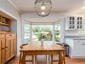 Bright dining area with a large bay window offering a view of the landscaped yard at 5533 97Th N Way, St Petersburg, FL 33708