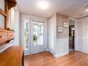 Inviting entryway with a glass front door, wood flooring, and ample closet space at 5533 97Th N Way, St Petersburg, FL 33708