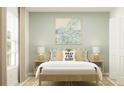 Inviting main bedroom featuring neutral decor, stylish lamps, a decorative wall painting and natural light at 5675 Yellow Hornbill Ave, Wimauma, FL 33598