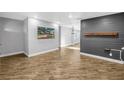 Spacious living room featuring wood-look floors, neutral paint, and accent wall at 712 43Rd N Ave, St Petersburg, FL 33703