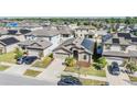 Aerial view of a residential neighborhood highlighting solar panels on the roof at 11922 Winterset Cove Dr, Riverview, FL 33579