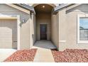 Inviting front entrance with a dark-colored door and decorative landscaping at 11922 Winterset Cove Dr, Riverview, FL 33579