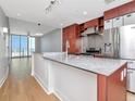 Modern kitchen with granite countertops, stainless steel appliances and island with breakfast bar at 1208 E Kennedy Blvd # 1121, Tampa, FL 33602