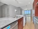 Bright, modern kitchen with stainless steel appliances, light wood floors, and expansive windows showcasing scenic views at 1208 E Kennedy Blvd # 1121, Tampa, FL 33602