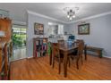 Cozy dining area with hardwood floors, a wooden table, and easy access to the kitchen at 1304 Kelridge Pl, Brandon, FL 33511
