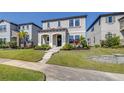 Charming two-story home featuring a well-manicured lawn and inviting front entrance, flanked by lush landscaping at 13319 Dorado Shores Ave, Riverview, FL 33579