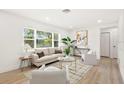 Bright living room features a large window and contemporary furnishings, creating a welcoming and airy atmosphere at 1410 San Charles Dr, Dunedin, FL 34698